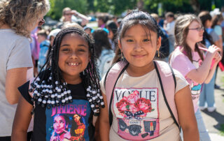 First day of school photo 2024. Two elementary students getting ready to go into the school.